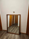 Vintage classic rectangular mirror featuring a warm-toned wooden frame