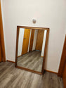 Vintage classic rectangular mirror featuring a warm-toned wooden frame