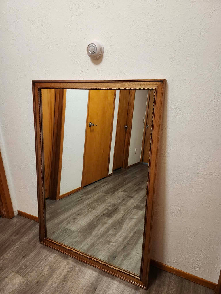 Vintage classic rectangular mirror featuring a warm-toned wooden frame