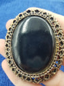Black resin brooch